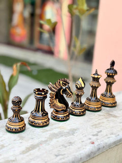 Alexandria Luxury Staunton burnt chess pieces set, hand-carved in boxwood, displaying king, queen, rook, bishop, knight, and pawn.