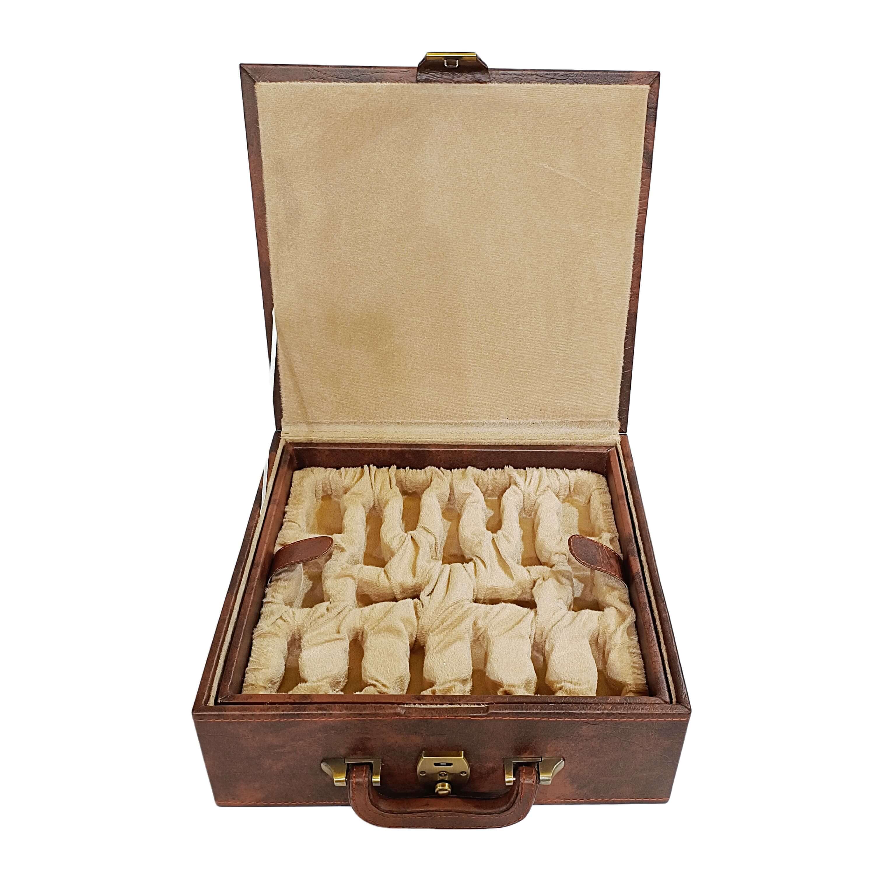 Open chess storage box with dual tray design, brown leatherette, filled with neatly arranged chess pieces.