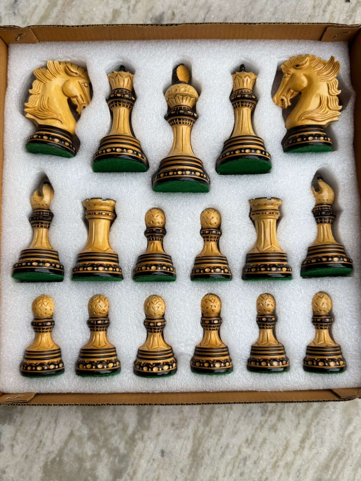 Alexandria luxury Staunton burnt chess pieces set, hand carved, featuring knights, kings, queens, and pawns in a box.