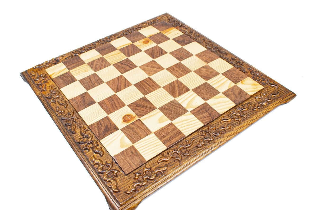 Hand carved wooden chess board with decorative edges, featuring a classic checker pattern in light and dark wood.