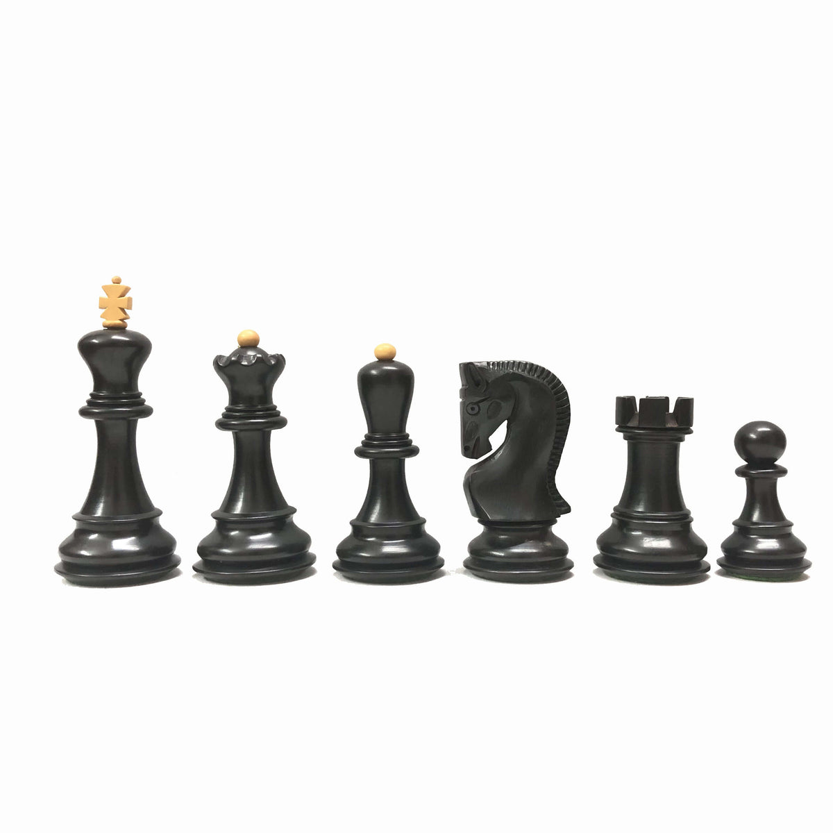 Ebonized chess pieces showcasing king, queen, knight, rook, and pawn designs; elegant and luxurious.