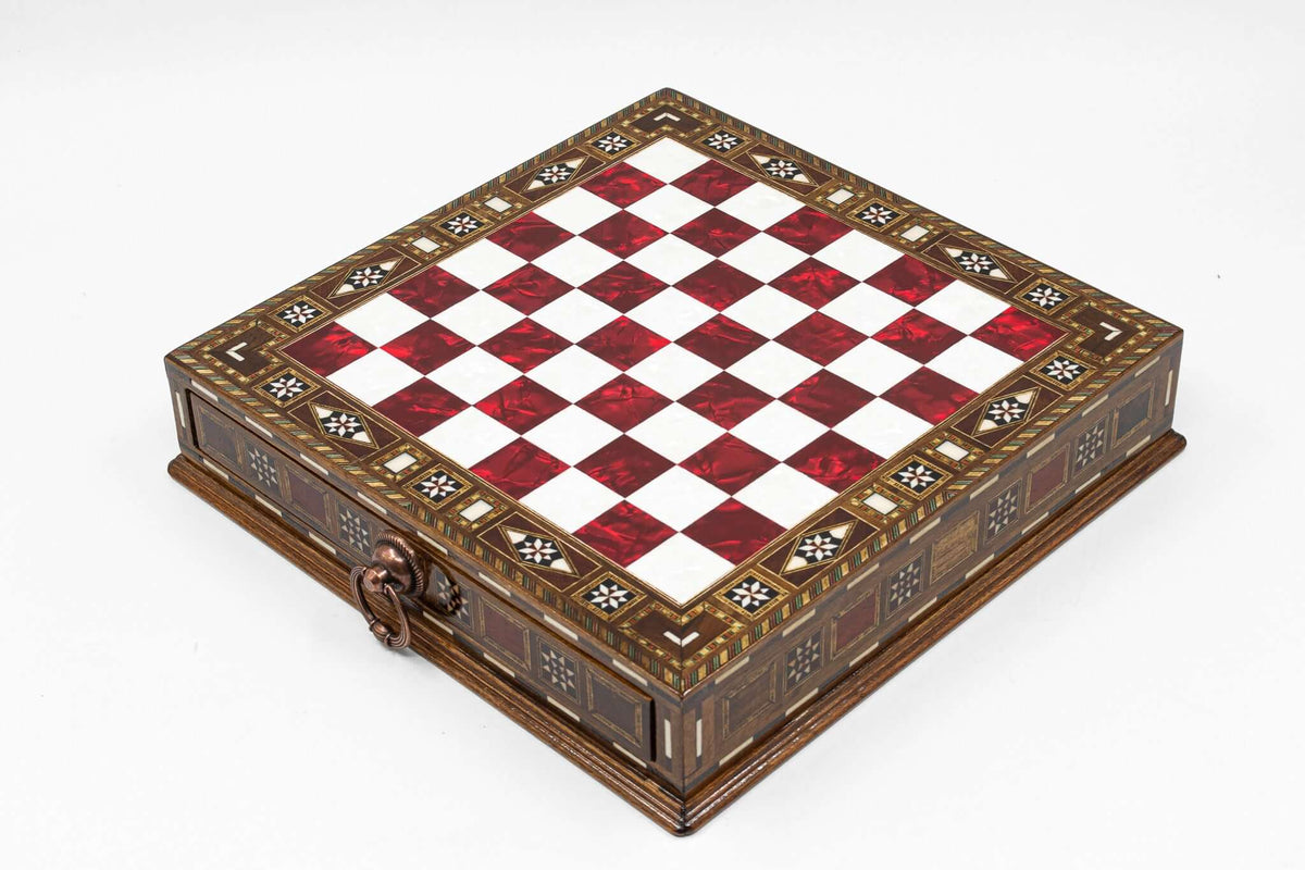 Elegant chess board with a red and white checkered pattern and ornate decorative edges.