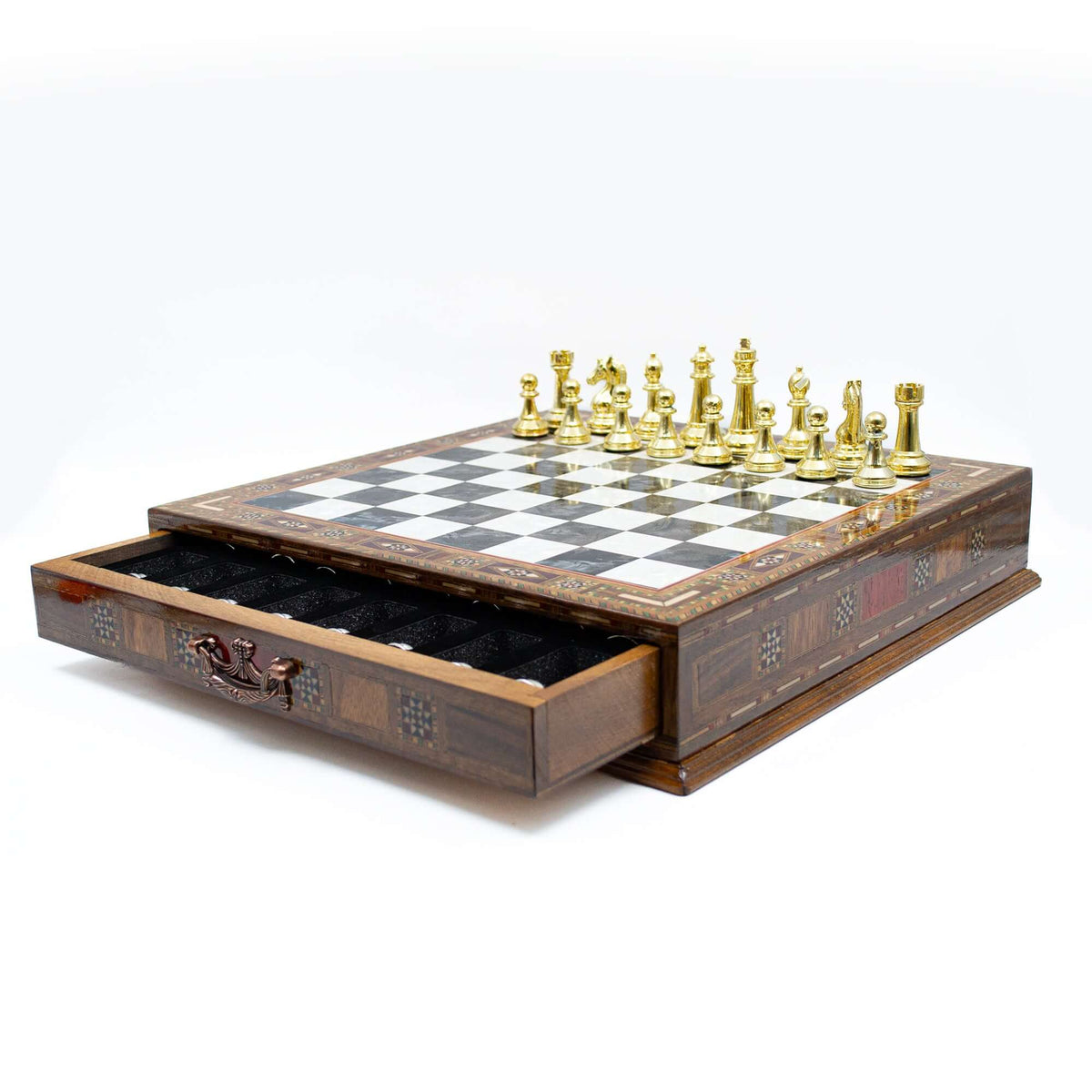 A luxury wooden chess set with a black board featuring gold and silver metal chess pieces. The set includes integrated storage units in the design.