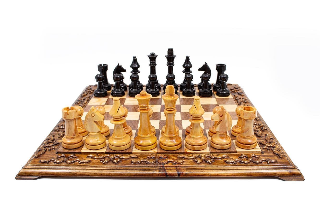 Hand carved wooden chess set with unique Staunton pieces on a decorative board, perfect for collectors and enthusiasts.
