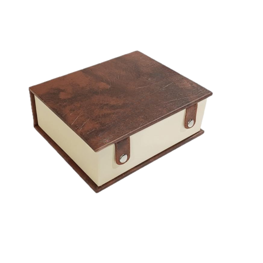 Leatherette chess storage box in book design, featuring a brown top and cream-colored sides with snap closures.
