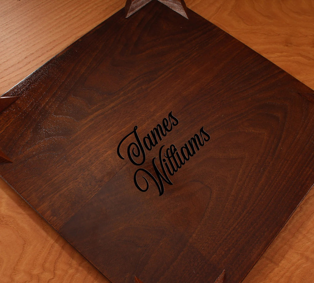 Engraved wooden chessboard featuring the name 'James Williams' on a polished surface.
