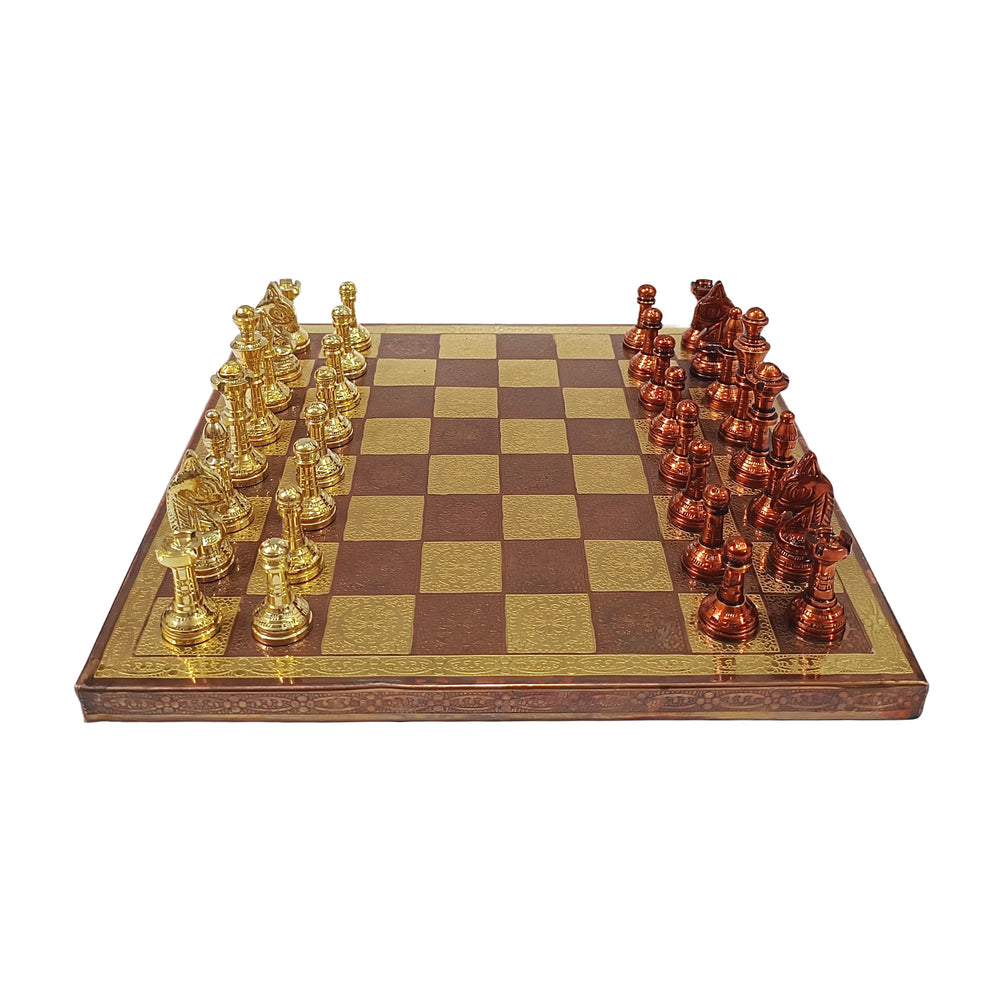 Classic Staunton style brass chess set with gold and copper pieces on a wooden chessboard.