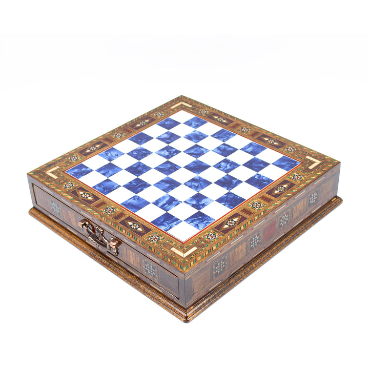 Decorative chess board with blue and white squares, intricate wooden design, and metal clasp.