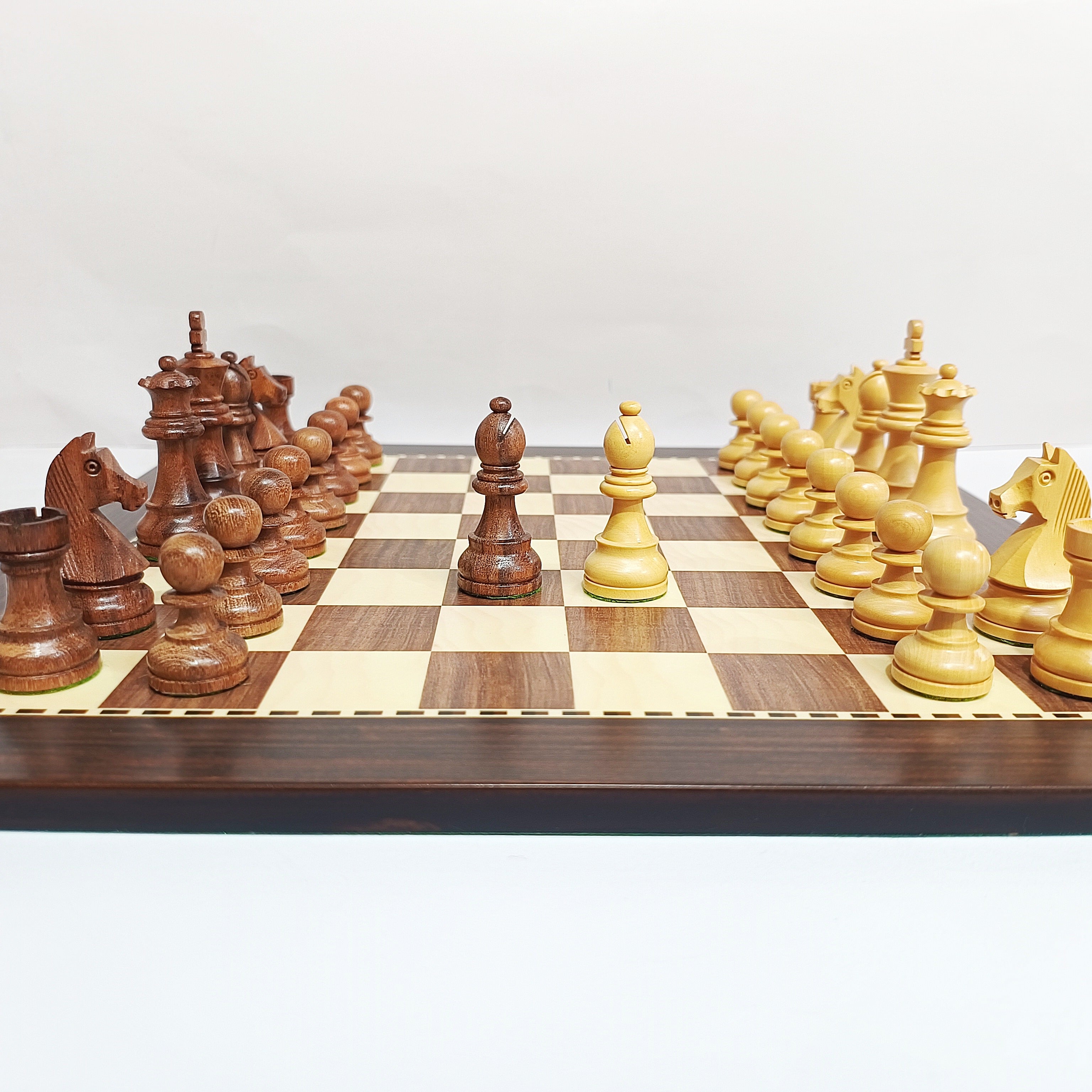 Classic Staunton wooden chess pieces on a brown and beige MDF chess board, ready for tournament play.